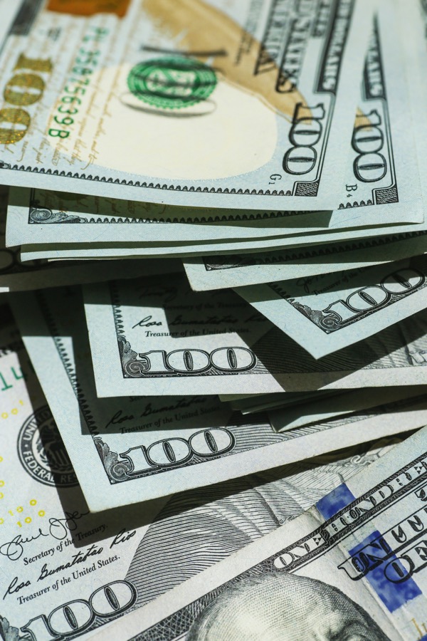 Stacked United States one hundred dollar bills representing the city budget