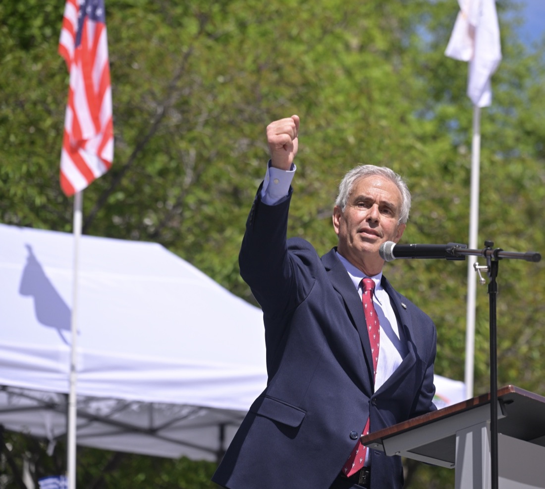 Taso Zografos speaking to supporters at an outdoor community event